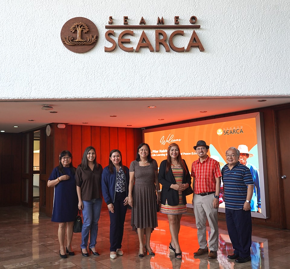 Ms. Soledad Villanueva (third from the right), PSDS of DepEd Los Baños, Laguna Sub-office, and Ms. Pilar Habito (center), Chief Executive Officer, and Mr. Arturo Cariaga (rightmost), both Life Learning Organization of Peace, pose with SEARCA representatives led by Center Director Dr. Glenn Gregorio (second from the right).