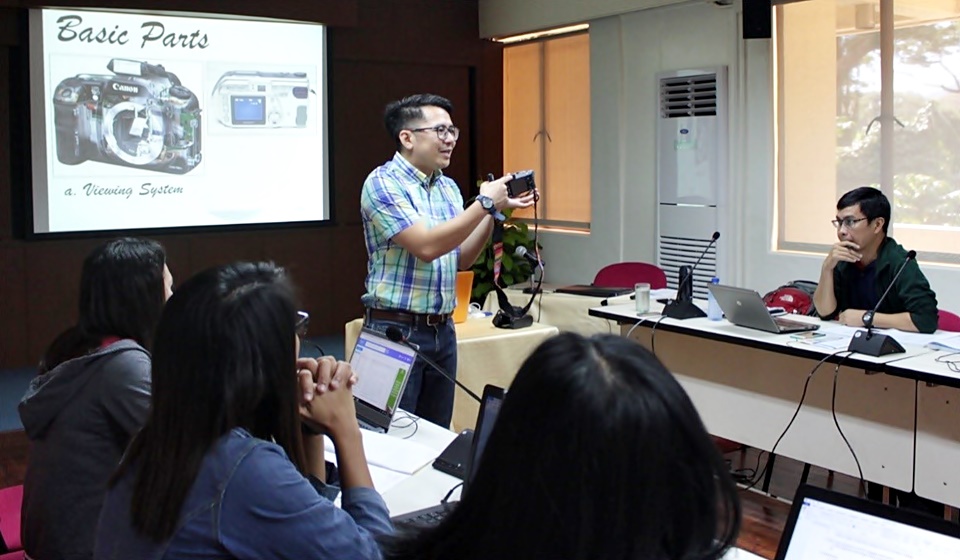 Asst. Prof. Edmund Centeno (standing), mentor for Photography and Audio-Visual Writing and Production, shows the basic parts of a camera.