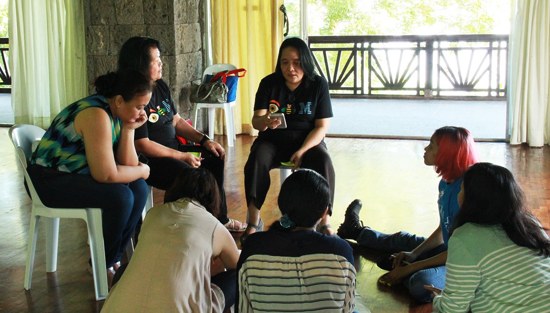 Dr. Maria Monina Villena brainstorming with groupmates during the design thinking workshop