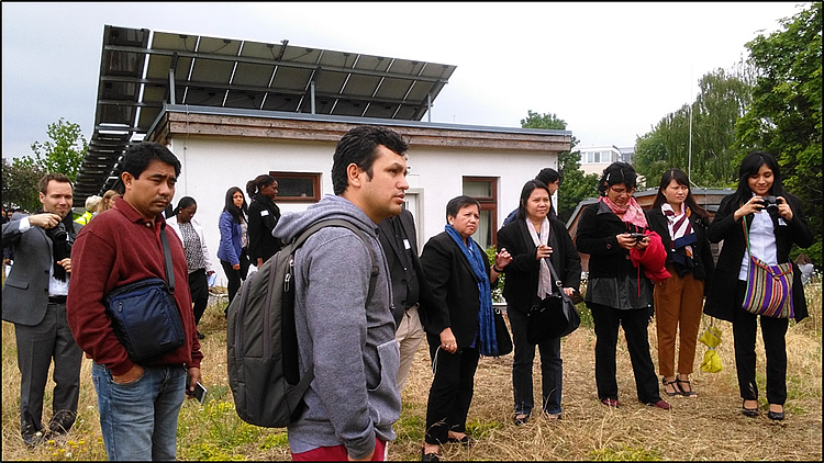 DELEGATES AT THE GREEN ROOF. The delegates of the International EbA Community of Practice Workshop visit an EbA best practice with the green roof, solar panel and water harvesting facility. This system is practiced in other communities in Germany including high end property urban development. 