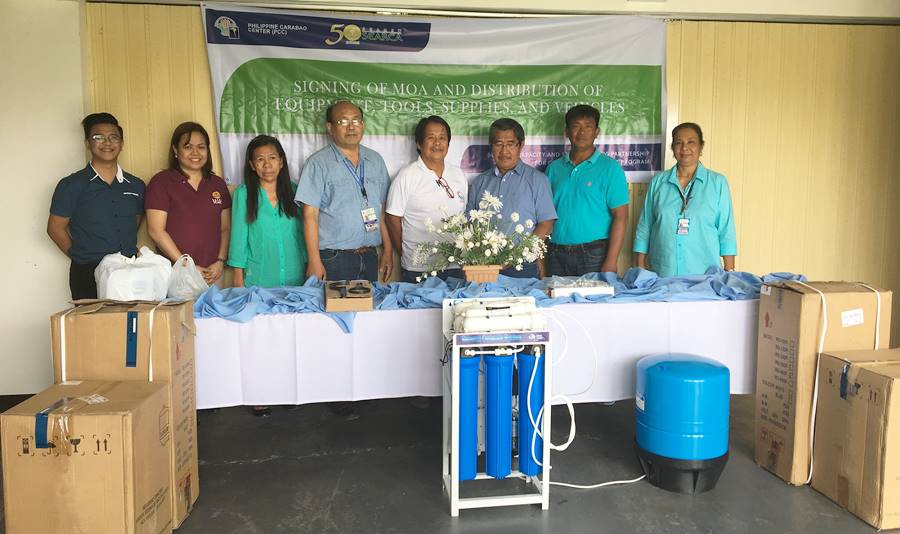 L-R: Mr. Zadieshar Sanchez, Administrative Officer V, PCC OED; Ms. Nancy Landicho, SEARCA Program Specialist; Ms. Lolita Aganon, Book Keeper, CAVAFEDCO; Dr. Franklin Rellin, Center Director, PCC CSU; Mr. Nestor Bautista, Chairman, CAVAFEDCO; Mr. Gilbert Benigno, Chairman, SADACO; Mr. Juan Agabin, Manager, IFC; and Ms. Edelina Rellin, Senior Science Research Specialist, PCC CSU during the distribution of water distillers to CBED cooperatives